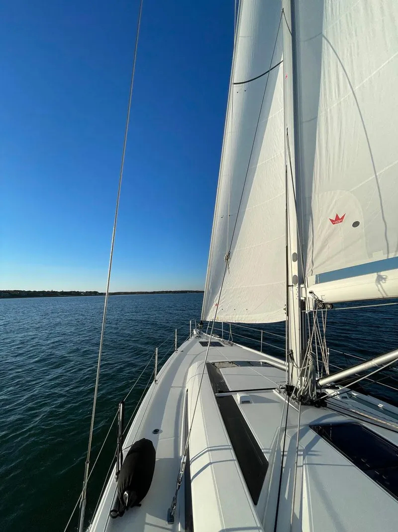 Slide: The Image of 2020 Beneteau Oceanis 51.1 sailing on calm waters under clear blue skies. - 6