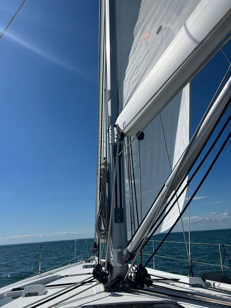 Slide: The Image of Sailing on a 2020 Beneteau Oceanis 51.1 yacht under clear blue skies. - 7