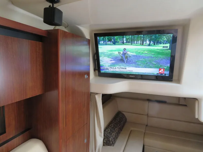 Slide: The Image of Interior of 2013 Monterey 340 Sport Yacht with TV and wooden cabinetry. - 14
