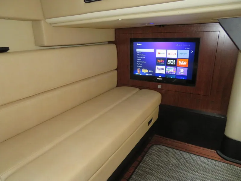 Slide: The Image of Luxurious interior of 2013 Monterey 340 Sport Yacht with beige seating and wall-mounted TV. - 16