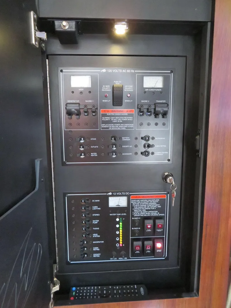 Slide: The Image of Electrical control panel inside a 2013 Monterey 340 Sport Yacht, featuring switches and indicators. - 18