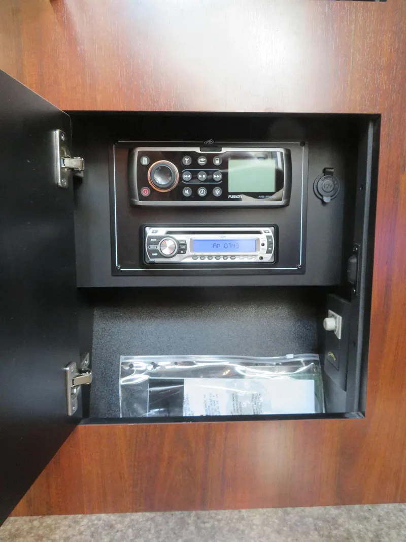 Slide: The Image of 2013 Monterey 340 Sport Yacht control panel with radio and navigation equipment. - 19