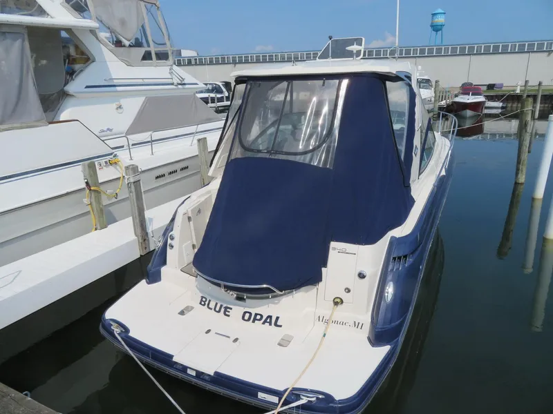 Slide: The Image of 2013 Monterey 340 Sport Yacht docked, featuring a blue cover and "Blue Opal" name. - 2