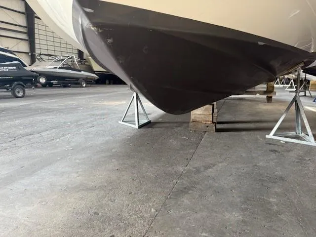 Slide: The Image of 2013 Monterey 340 Sport Yacht in storage, supported by stands in a warehouse. - 23