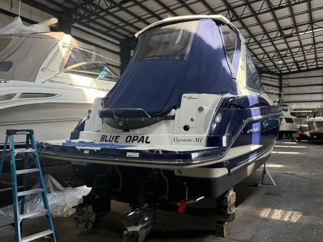 Slide: The Image of 2013 Monterey 340 Sport Yacht in storage, covered, with "Blue Opal" name visible. - 25