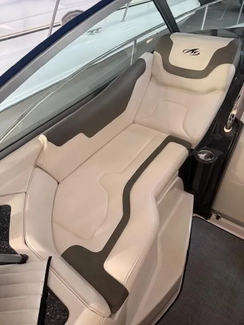 Slide: The Image of 2013 Monterey 340 Sport Yacht interior seating with white and gray upholstery. - 27