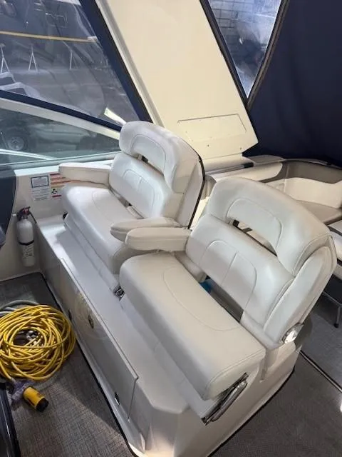 Slide: The Image of 2013 Monterey 340 Sport Yacht interior with white leather seats and coiled yellow rope. - 29
