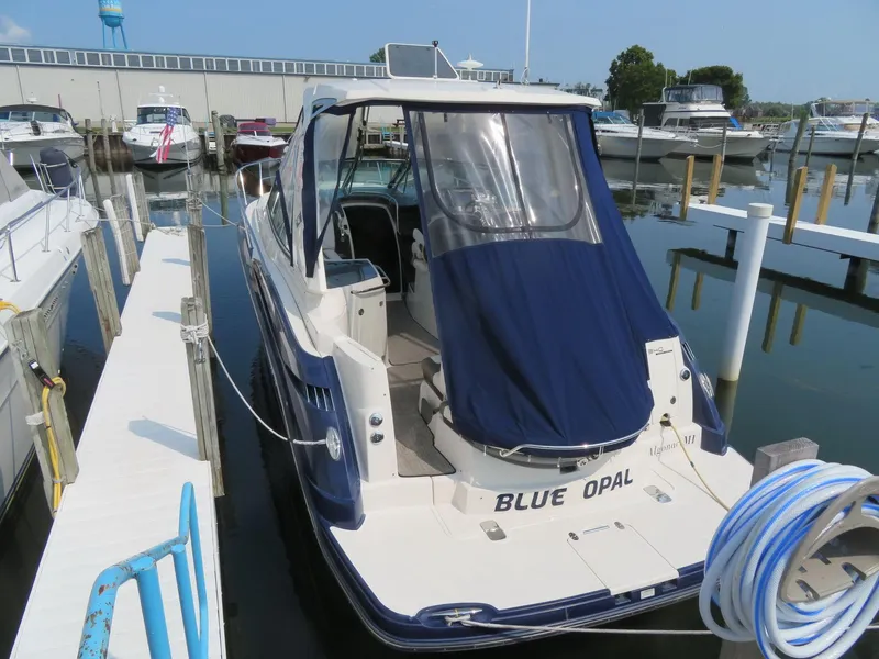 Slide: The Image of 2013 Monterey 340 Sport Yacht docked, featuring "Blue Opal" name and blue cover. - 3