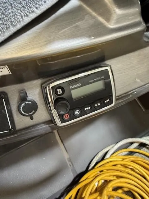 Slide: The Image of Fusion audio system on 2013 Monterey 340 Sport Yacht dashboard with coiled cables nearby. - 36