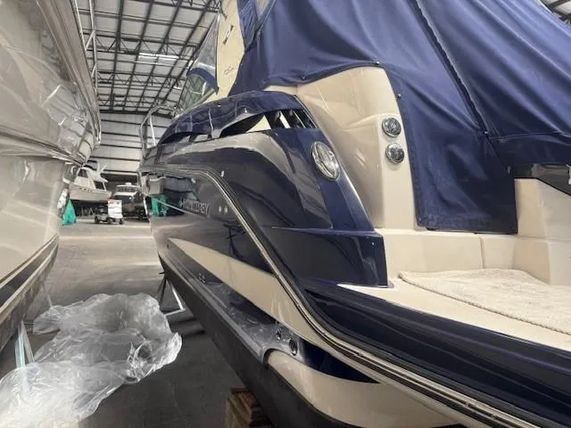 Slide: The Image of 2013 Monterey 340 Sport Yacht in storage, featuring sleek blue and white design. - 39