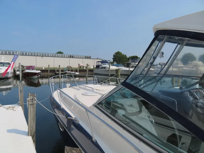 Slide: The Image of 2013 Monterey 340 Sport Yacht docked at a marina under clear blue skies. - 4