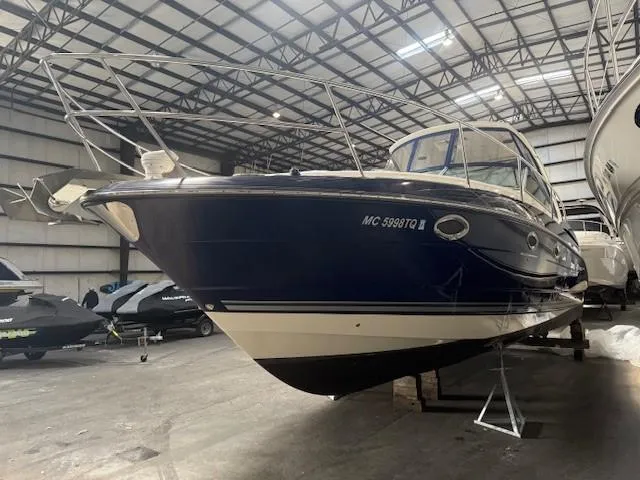 Slide: The Image of 2013 Monterey 340 Sport Yacht in storage, showcasing sleek design and navy blue hull. - 40