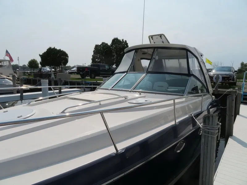 Slide: The Image of 2013 Monterey 340 Sport Yacht docked, showcasing sleek design and spacious deck. - 41