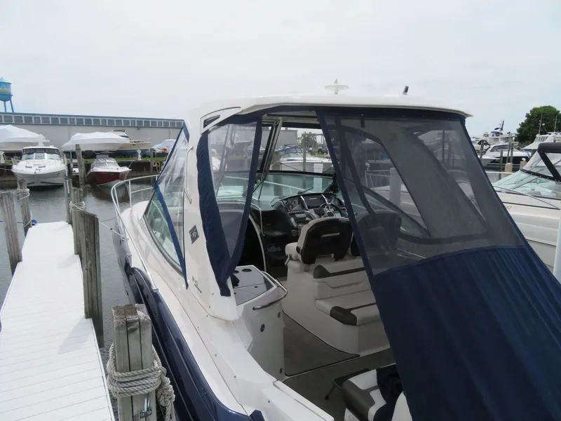 Slide: The Image of 2013 Monterey 340 Sport Yacht docked, featuring sleek design and covered cockpit. - 46