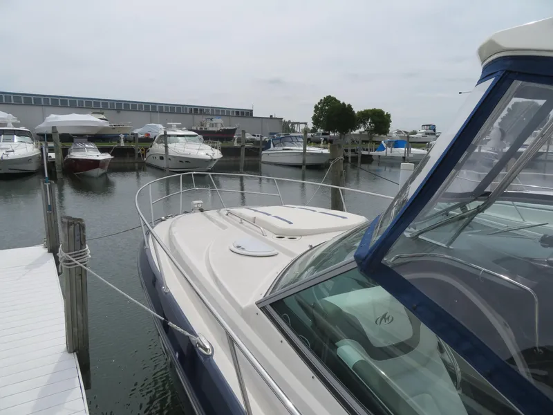 Slide: The Image of 2013 Monterey 340 Sport Yacht docked at marina with other boats. - 47