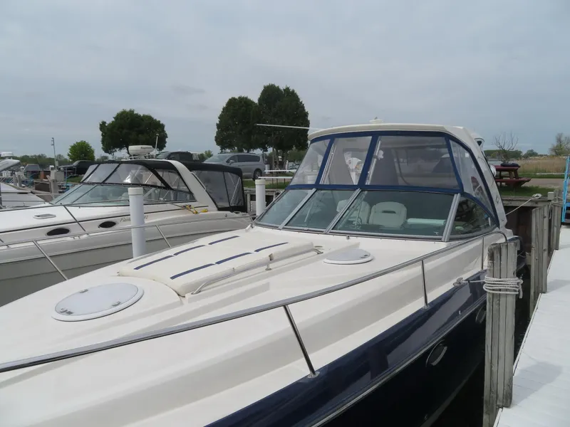 Slide: The Image of 2013 Monterey 340 Sport Yacht docked at marina, featuring sleek design and spacious deck. - 48