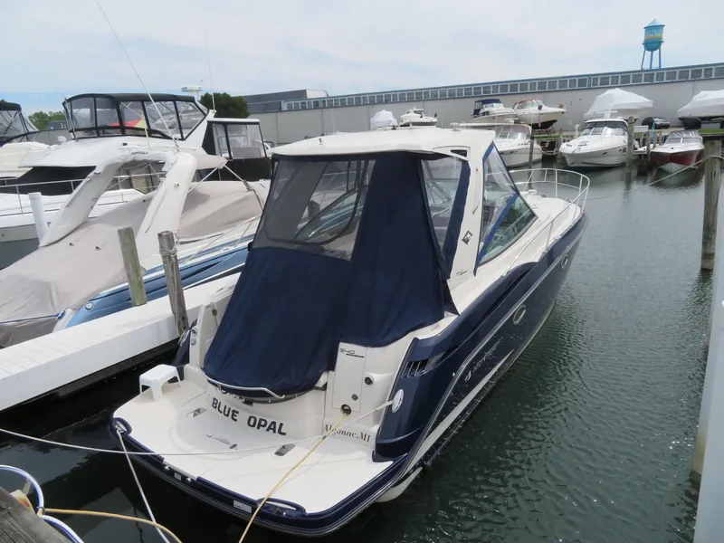 Slide: The Image of 2013 Monterey 340 Sport Yacht docked in marina, featuring blue and white exterior. - 49