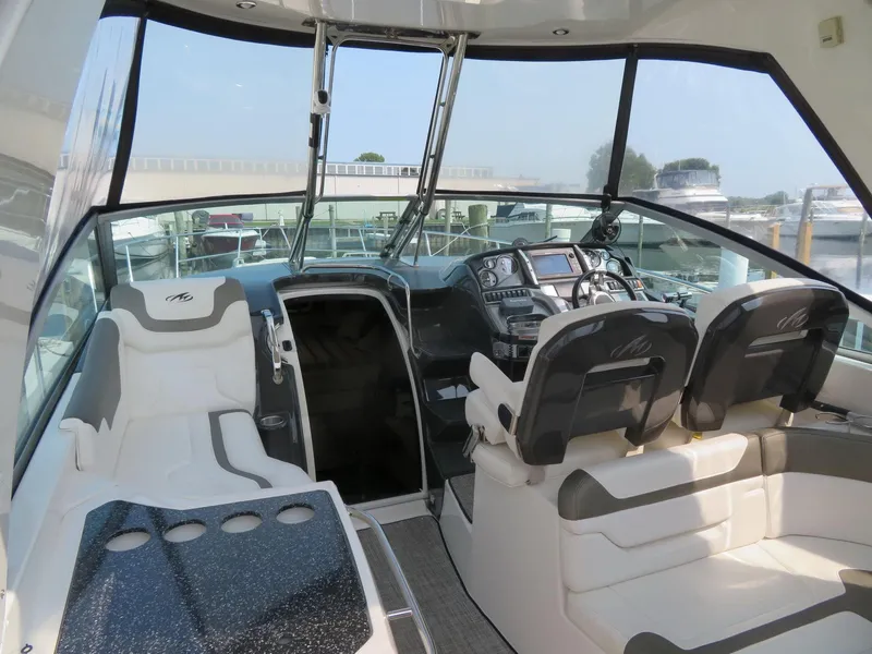 Slide: The Image of 2013 Monterey 340 Sport Yacht cockpit with modern controls and comfortable seating. - 5