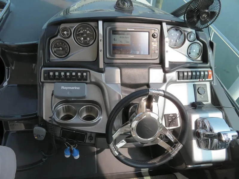 Slide: The Image of Control panel of a 2013 Monterey 340 Sport Yacht with steering wheel and navigation instruments. - 6