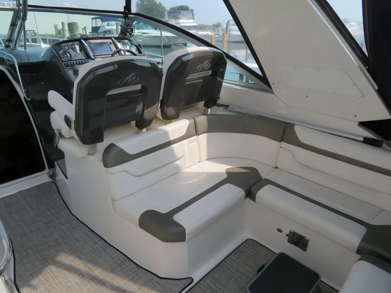 Slide: The Image of 2013 Monterey 340 Sport Yacht interior with plush seating and modern dashboard. - 8