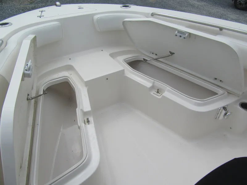 Slide: The Image of 2014 Robalo R200 Center Console boat with open storage compartments. - 10
