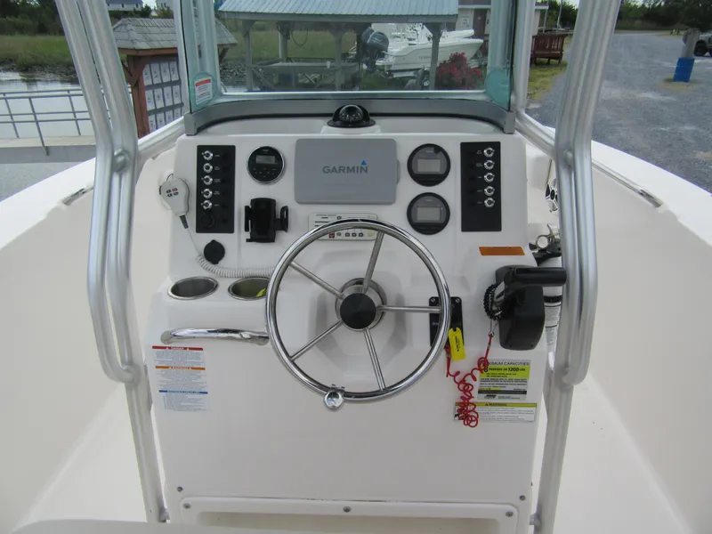 Slide: The Image of 2014 Robalo R200 Center Console boat dashboard with steering wheel and controls. - 5