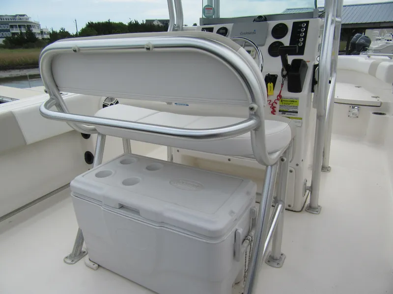 Slide: The Image of 2014 Robalo R200 Center Console boat interior with seating and cooler. - 7
