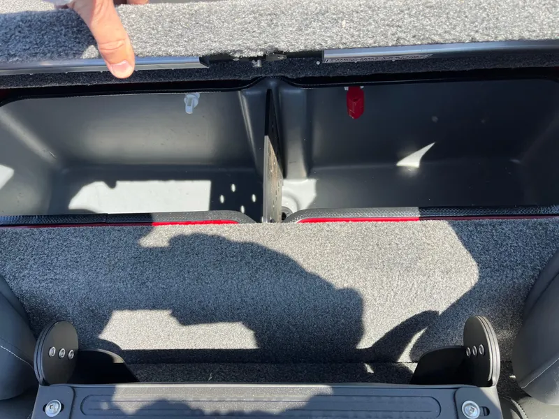 Slide: The Image of 2024 Ranger RT188 boat storage compartment with open lid, showcasing interior space and carpeted edges. - 11