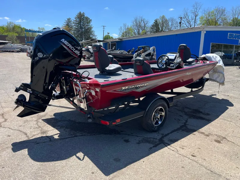 Slide: The Image of 2024 Ranger RT188 boat with Mercury engine, parked outdoors on a sunny day. - 2