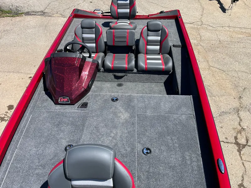 Slide: The Image of 2024 Ranger RT188 boat interior with red and gray seating, steering console, and spacious deck. - 4