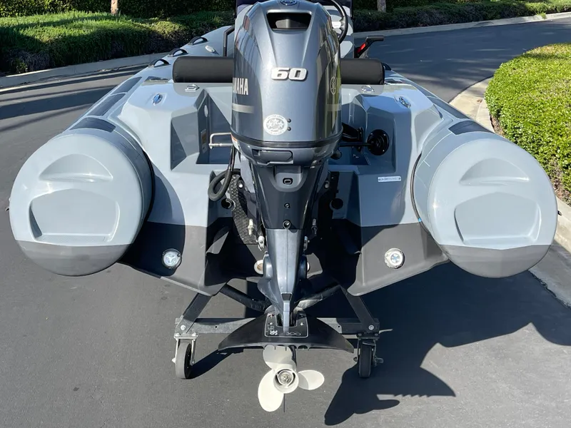 Slide: The Image of 2021 Brig Eagle 4 inflatable boat with Yamaha 60 engine, parked on a paved road. - 20