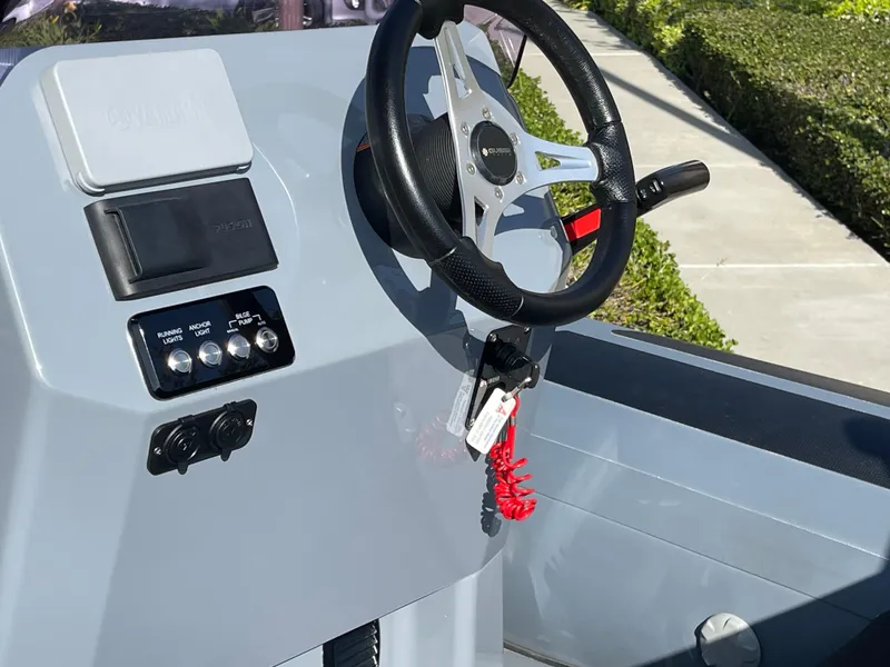 Slide: The Image of 2021 Brig Eagle 4 boat console with steering wheel and control panel. - 21