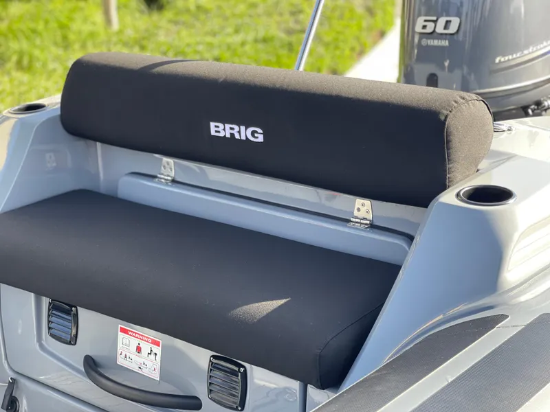 Slide: The Image of 2021 Brig Eagle 4 boat seat with Yamaha 60 engine in background. - 22