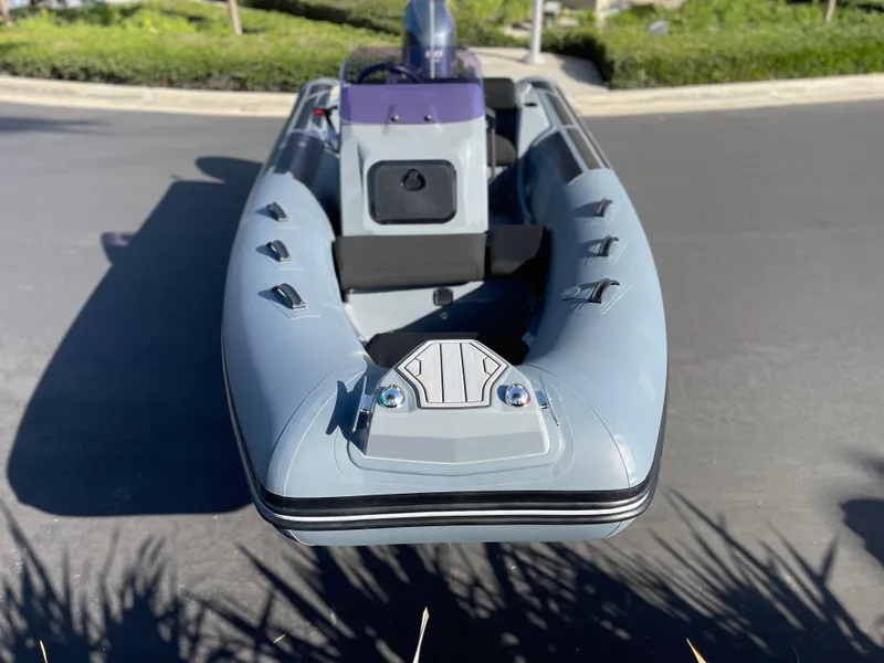 Slide: The Image of 2021 Brig Eagle 4 inflatable boat on pavement, showcasing sleek design and modern features. - 25