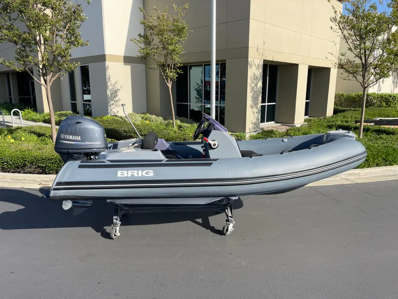 Slide: The Image of 2021 Brig Eagle 4 inflatable boat with Yamaha engine, parked outdoors. - 29