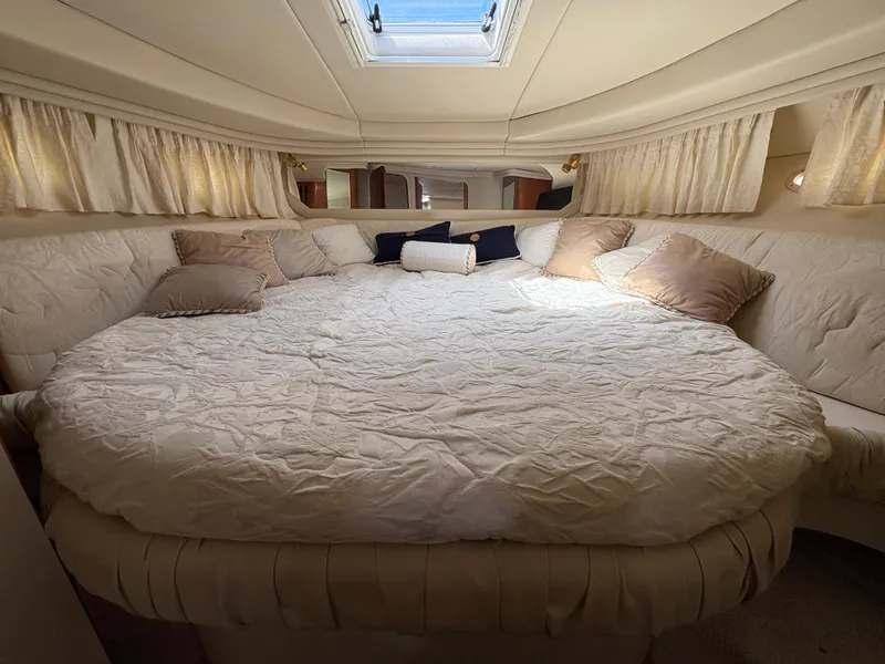 Slide: The Image of Luxurious cabin interior of 1999 Sea Ray 380 Sundancer with plush bedding and cushions. - 12