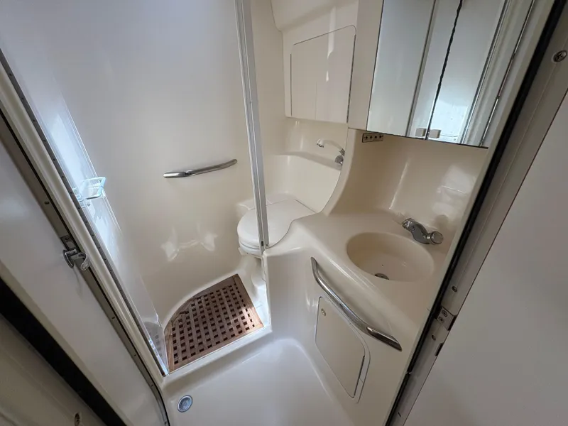 Slide: The Image of Bathroom interior of 1999 Sea Ray 380 Sundancer yacht, featuring shower and sink. - 13