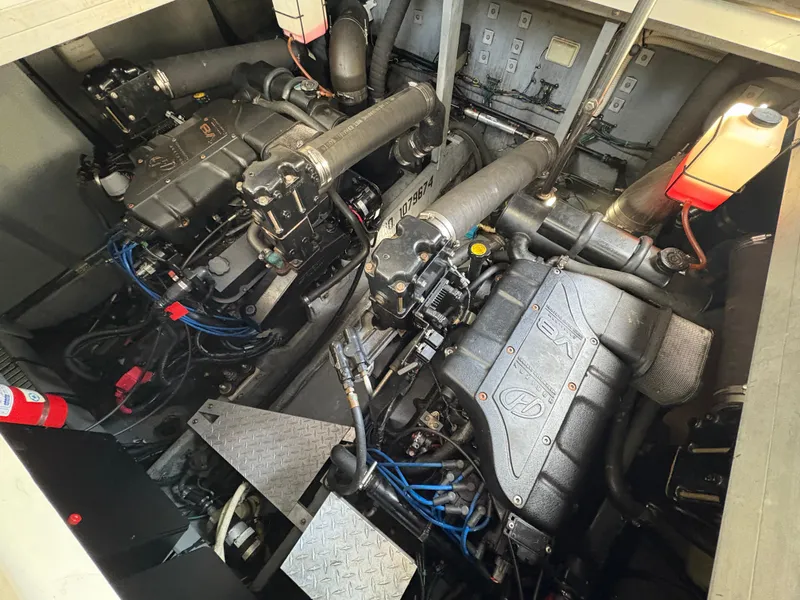 Slide: The Image of Engine room of 1999 Sea Ray 380 Sundancer with dual engines and mechanical components. - 14