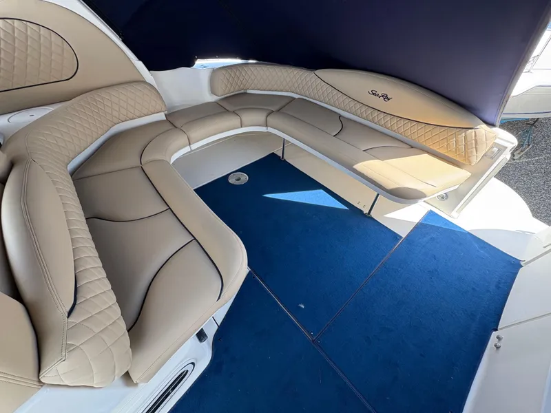 Slide: The Image of 1999 Sea Ray 380 Sundancer interior with beige seating and blue carpet. - 7