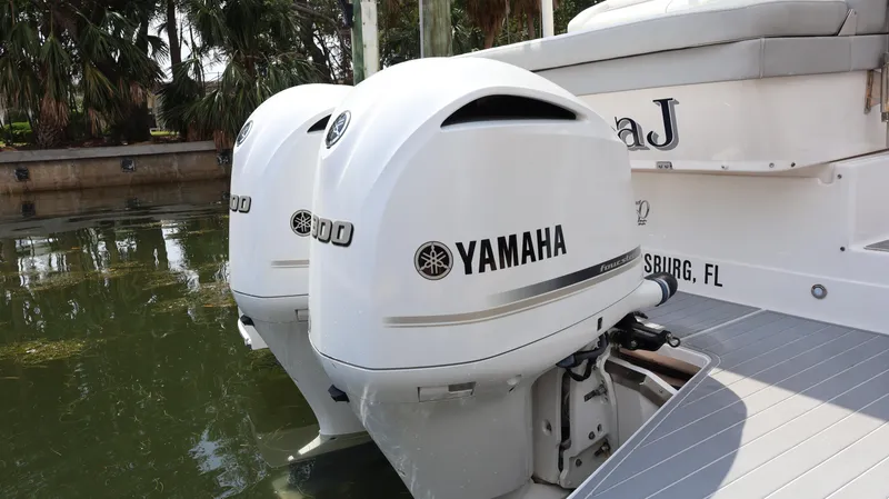 Slide: The Image of 2021 Regal 33 XO boat with dual Yamaha outboard engines on calm water. - 13