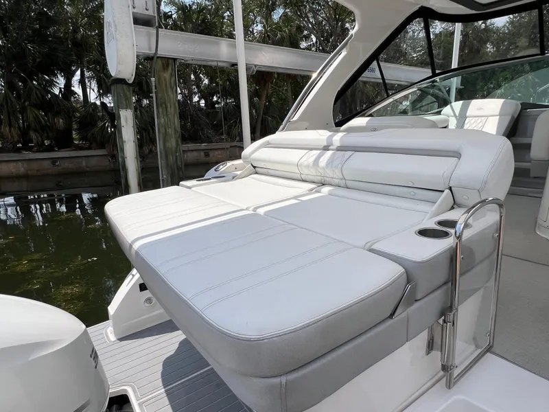 Slide: The Image of 2021 Regal 33 XO boat with luxurious white seating and cup holders. - 17