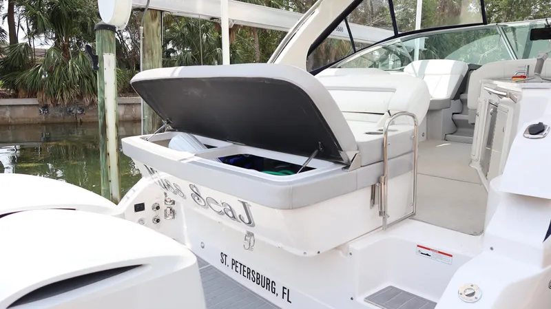 Slide: The Image of 2021 Regal 33 XO boat with open storage compartment, docked in St. Petersburg, FL. - 18