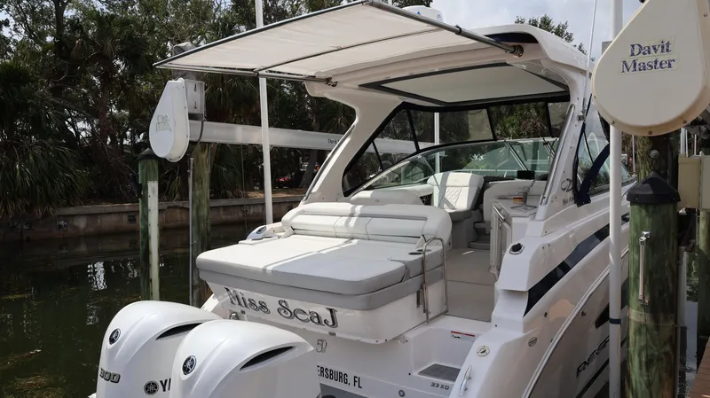 Slide: The Image of 2021 Regal 33 XO boat docked, featuring dual outboard engines and spacious seating. - 21