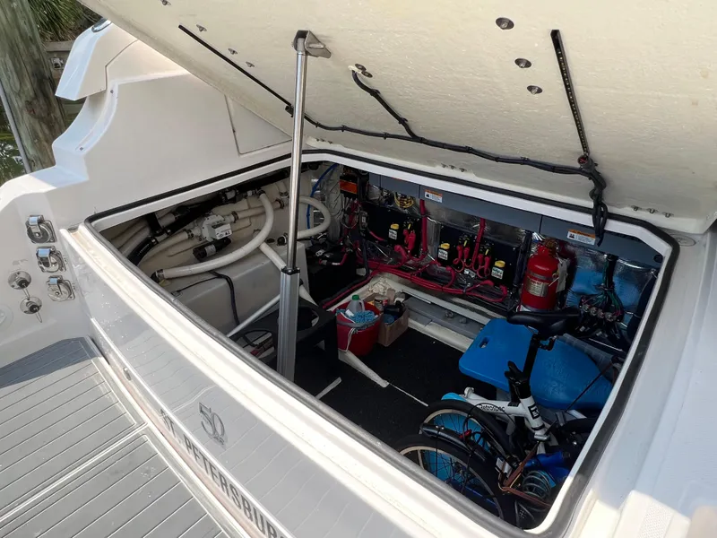 Slide: The Image of 2021 Regal 33 XO boat storage compartment with equipment and bicycle. - 24