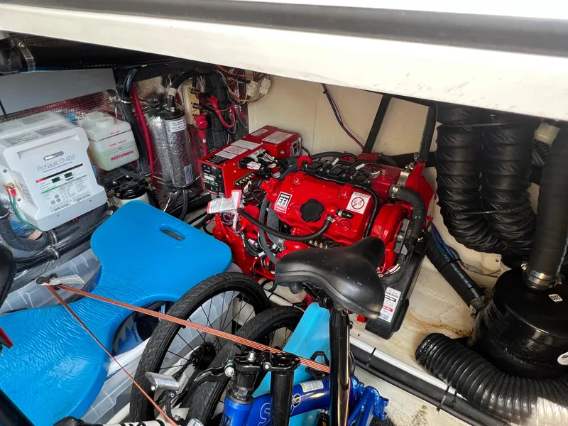 Slide: The Image of Engine room of 2021 Regal 33 XO boat with red engine and equipment. - 25