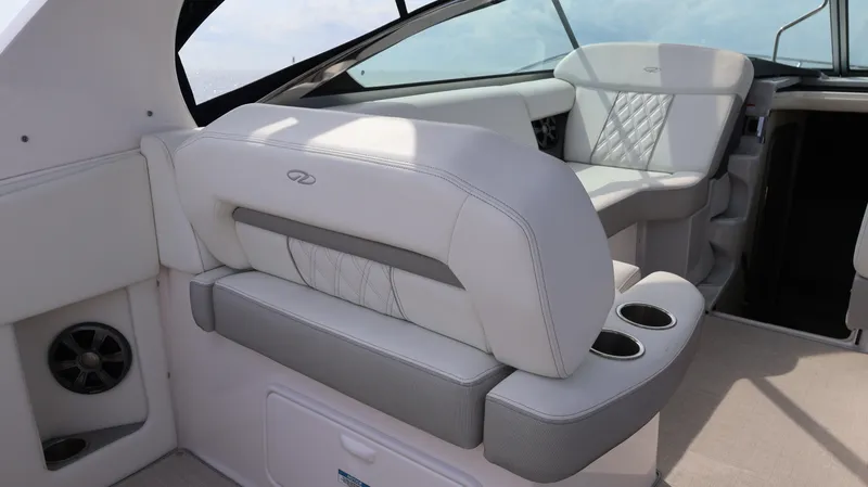 Slide: The Image of 2021 Regal 33 XO boat interior with luxurious white seating and cup holders. - 30