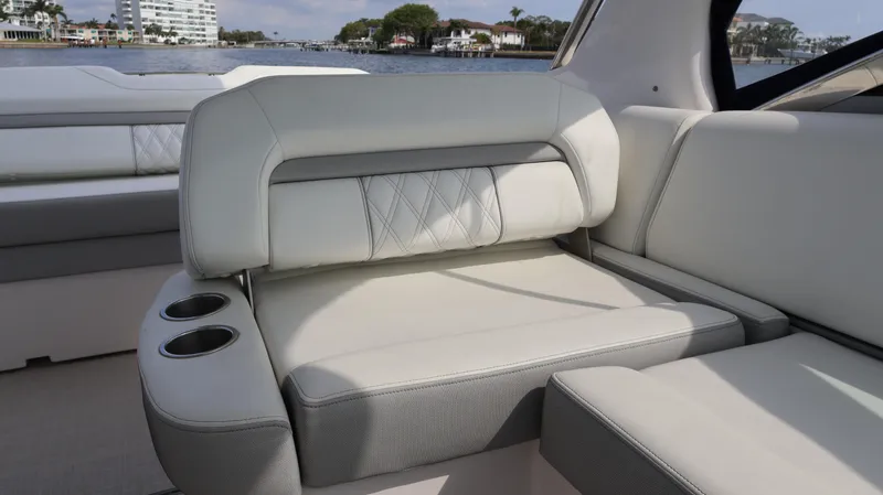 Slide: The Image of Luxurious seating on 2021 Regal 33 XO boat with cup holders, waterfront view. - 33