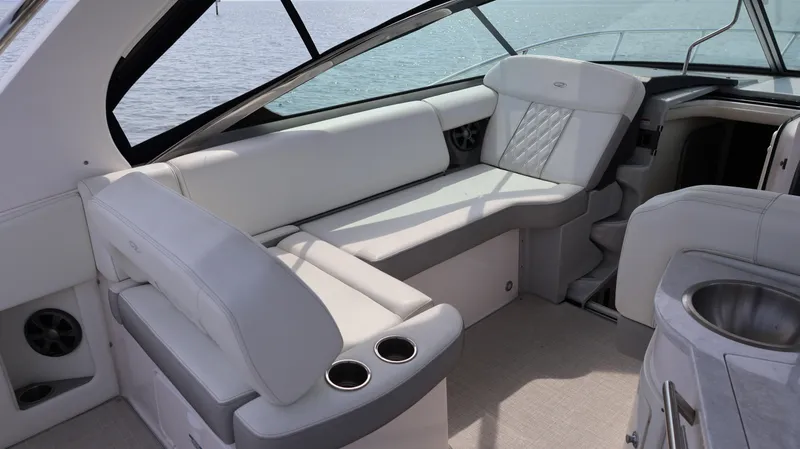 Slide: The Image of Luxurious interior of 2021 Regal 33 XO yacht with plush seating and cup holders. - 34