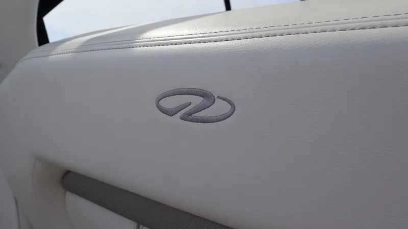 Slide: The Image of 2021 Regal 33 XO boat interior with embroidered logo on white upholstery. - 35