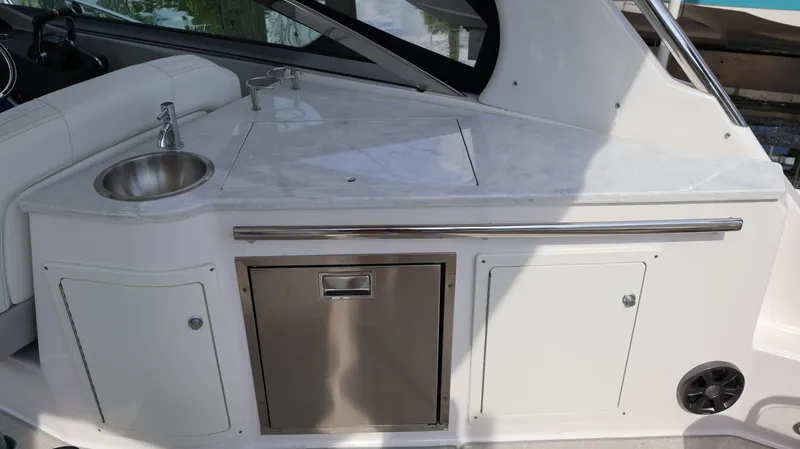 Slide: The Image of 2021 Regal 33 XO boat interior with sink and storage compartments. - 39